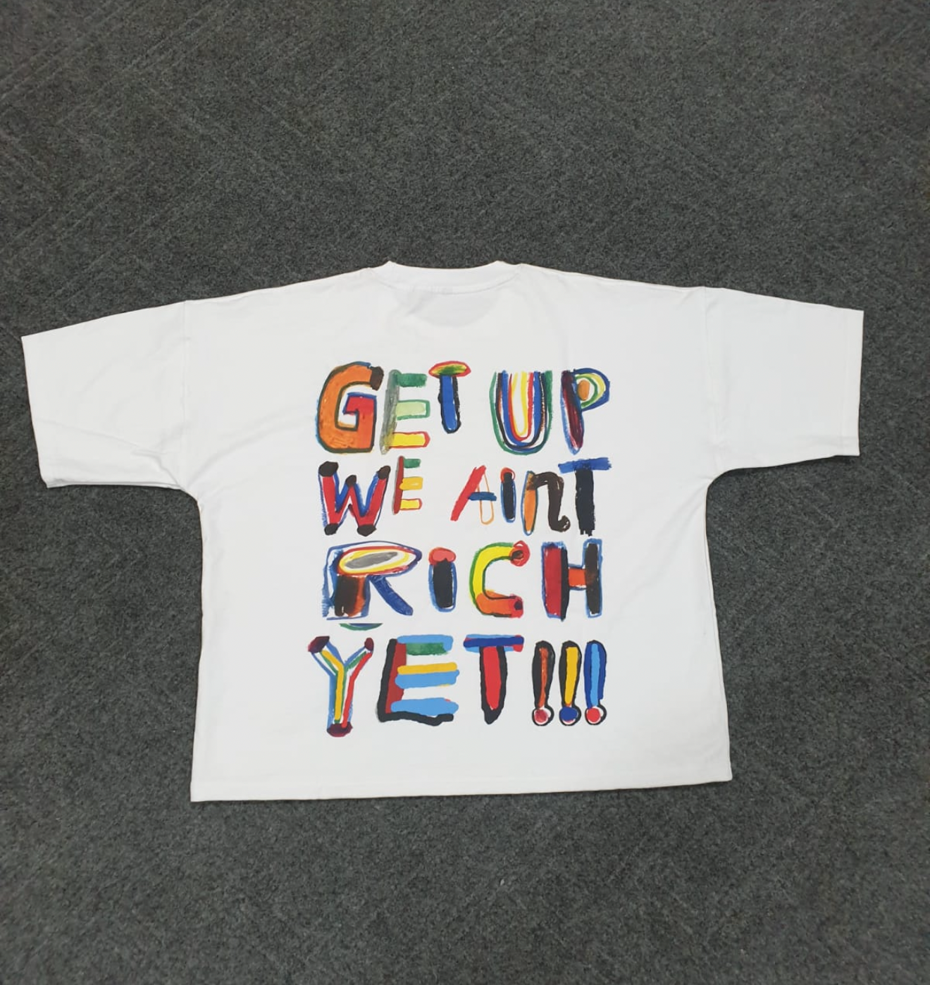 'We Ain’t Rich Yet” Statement Tee