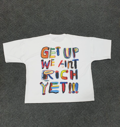 'We Ain’t Rich Yet” Statement Tee